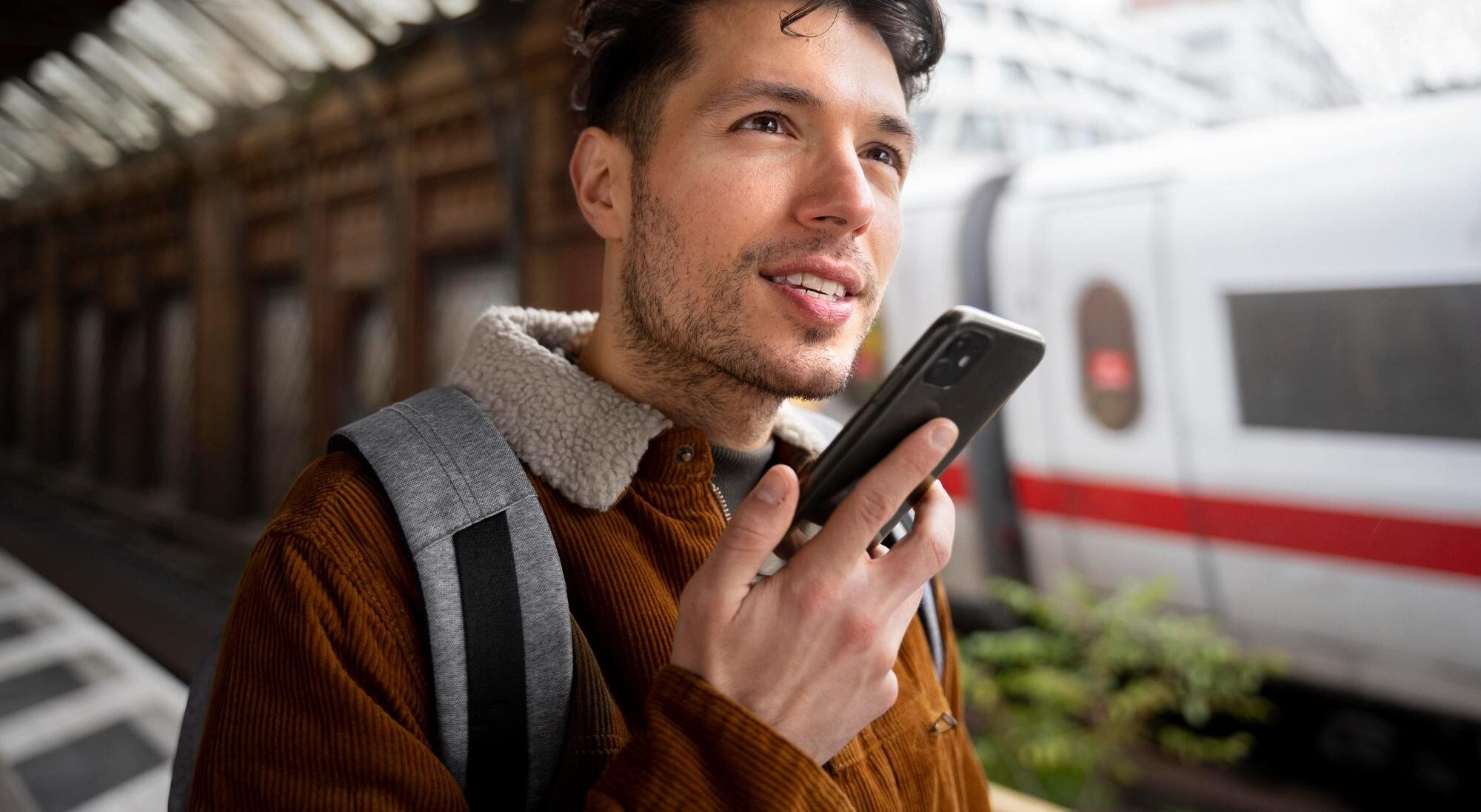 Man holding phone in the train station
