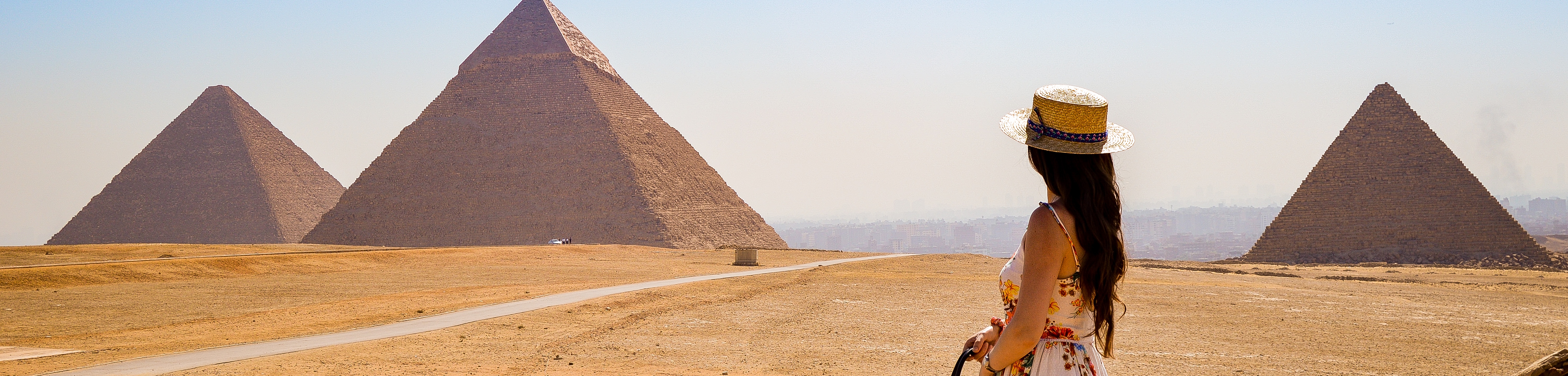 woman looking to pyramids